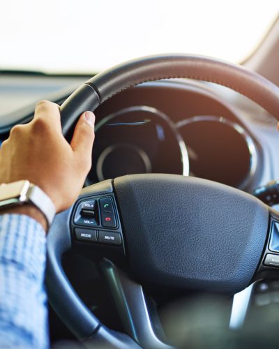 Always on the go. Cropped shot of an unidentifiable man driving a car